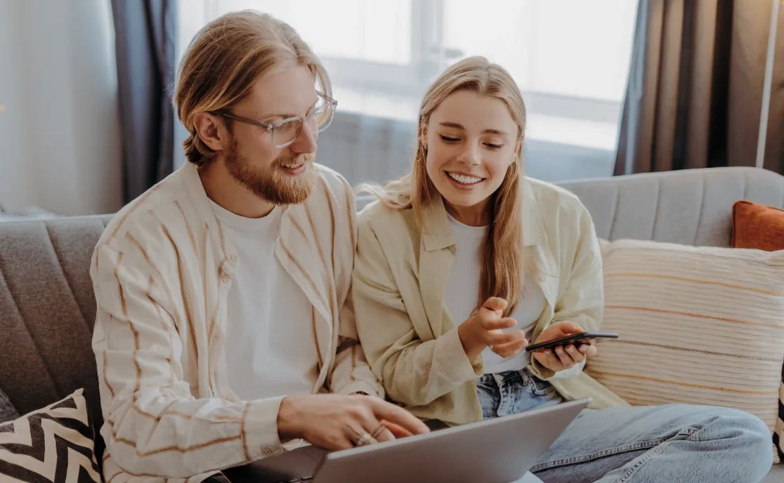 Two shop owners reviewing figures on a laptop