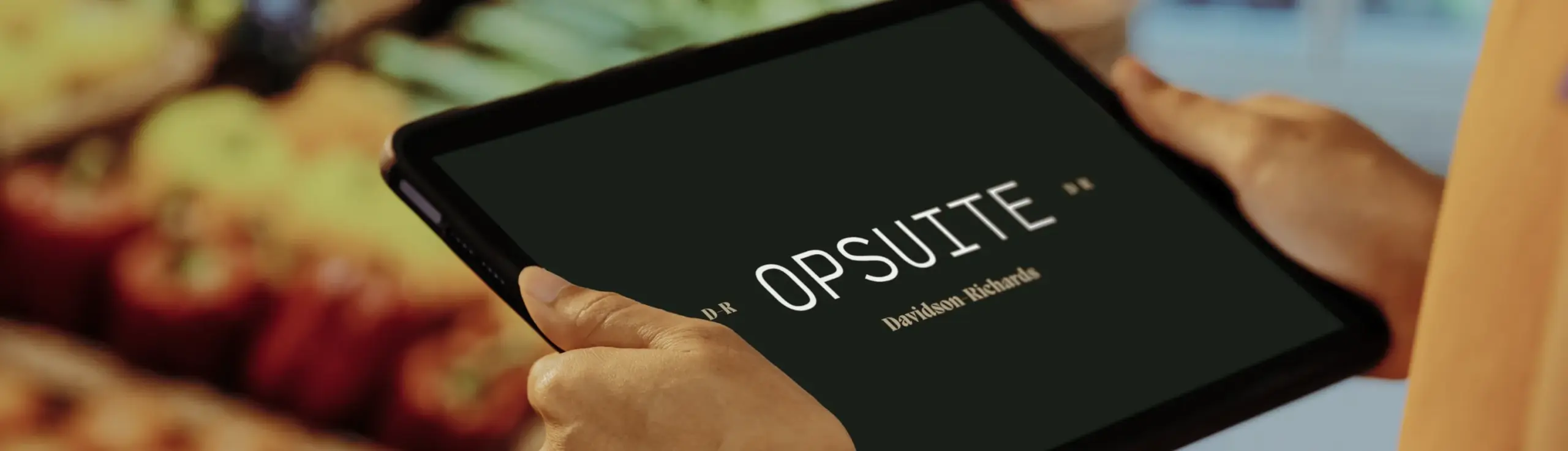 EPOS System CTA - customer holding tablet with OpSuite screen over produce