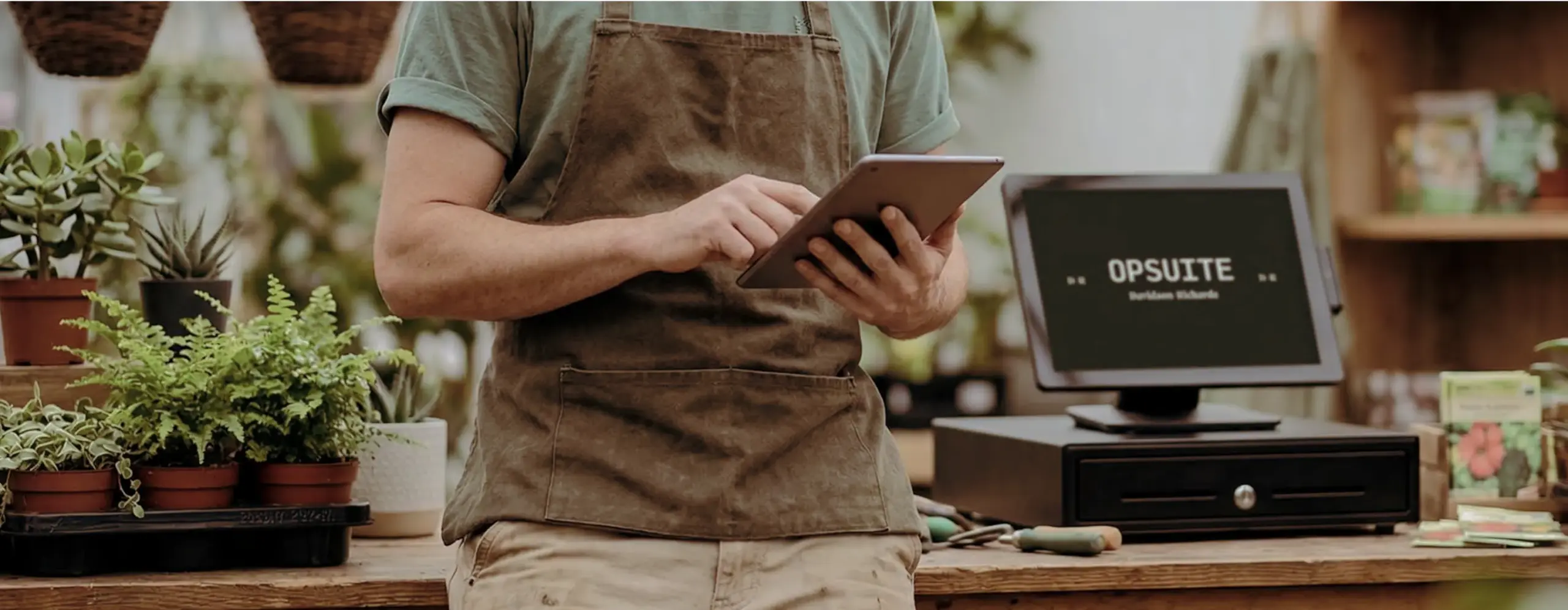 EPOS System hero - shop owner using tablet POS in garden centre
