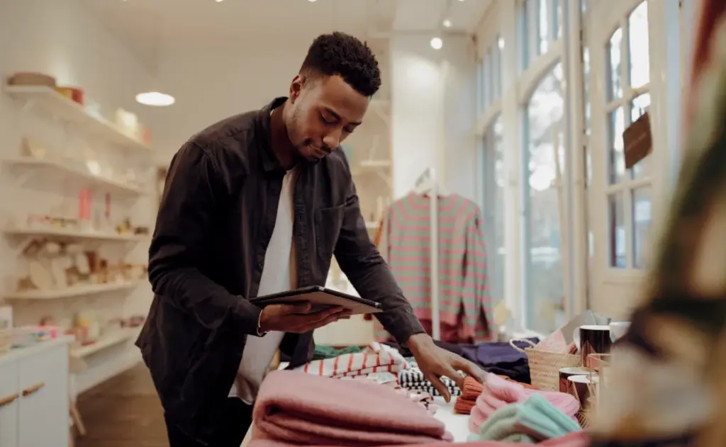 Two shop owners reviewing figures on a laptop