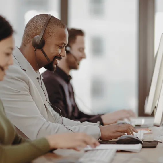 Davidson Richards support team at their desks wearing headsets