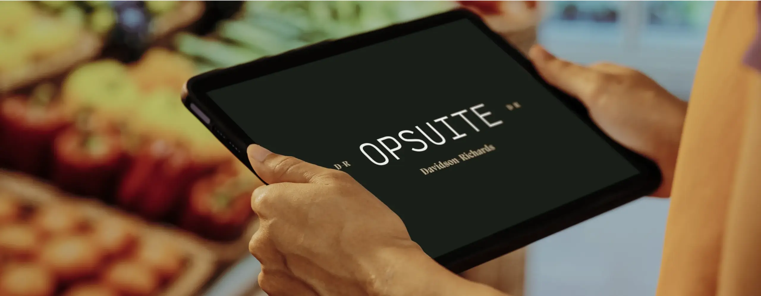 Retail colleague using OpSuite on a tablet in store